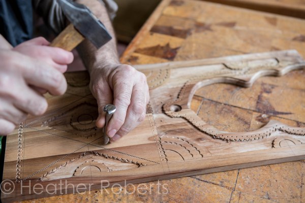 His hands seem so little next to this craftsman's.